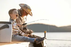 The Best Coolers For Boats, An old man and his grandson fishing